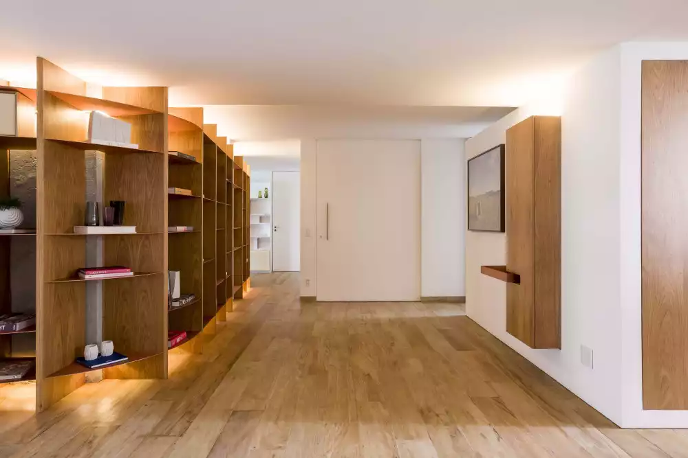 Living room with curved bookshelf entryway