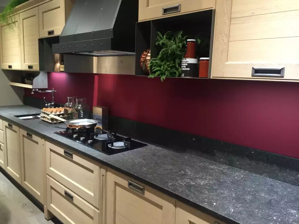 Modern kitchen with red backsplash and dark countertop