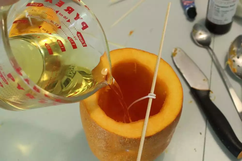Pour the hot wax into your pumpkin