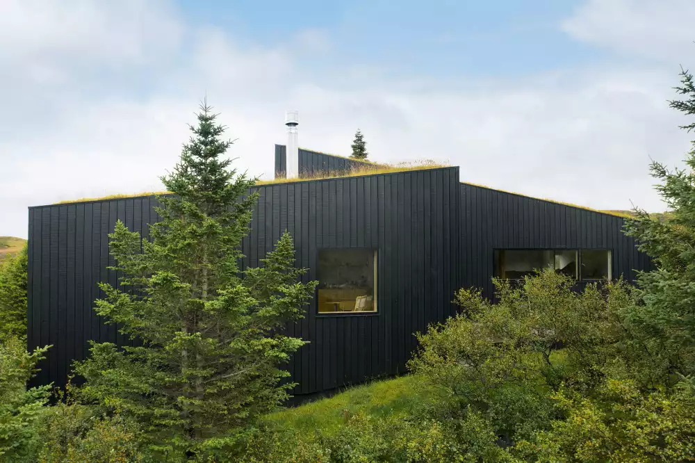 This holiday home designed by architecture office KRADS black facade