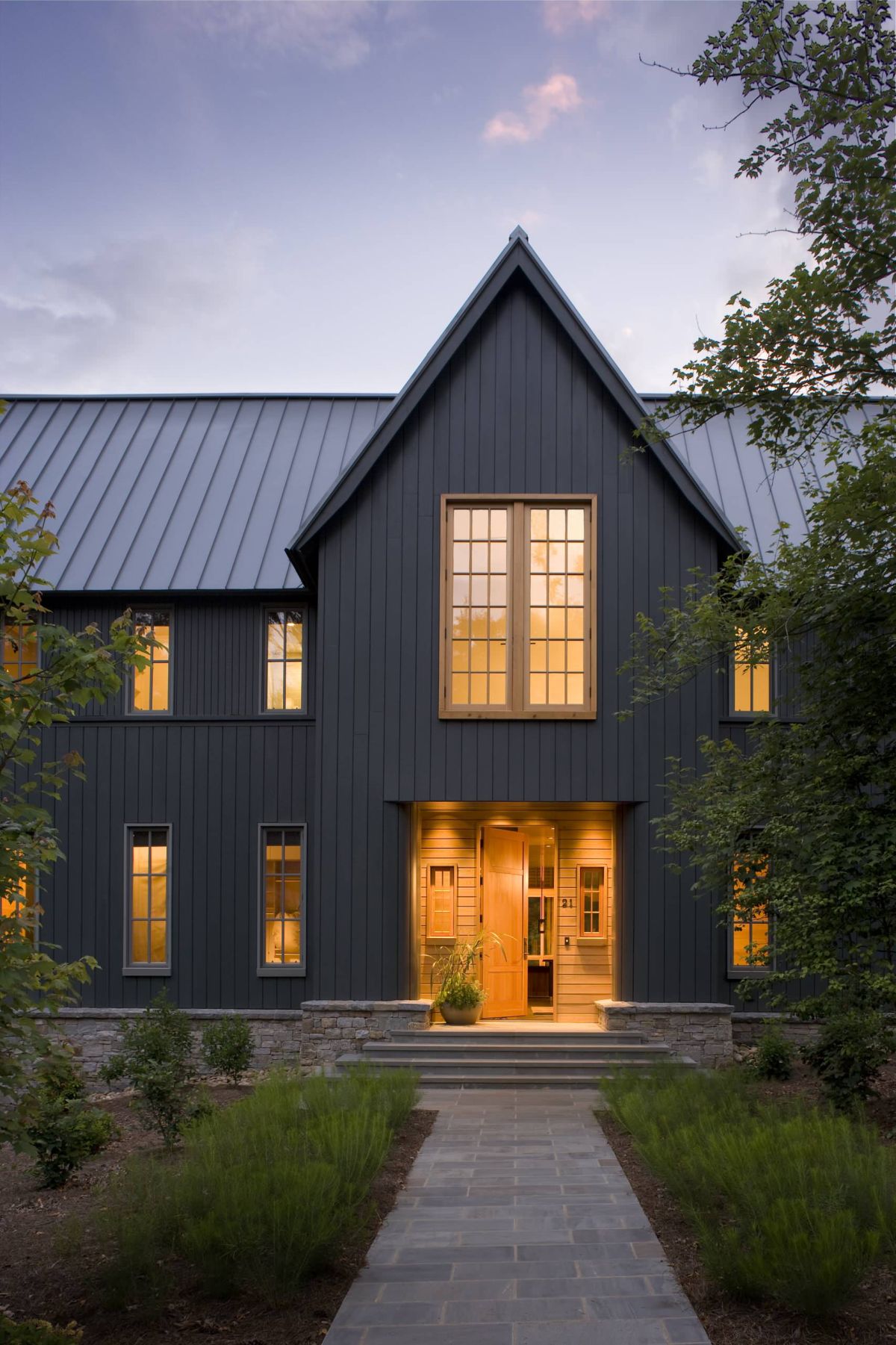 Black transitional house with vertical siding