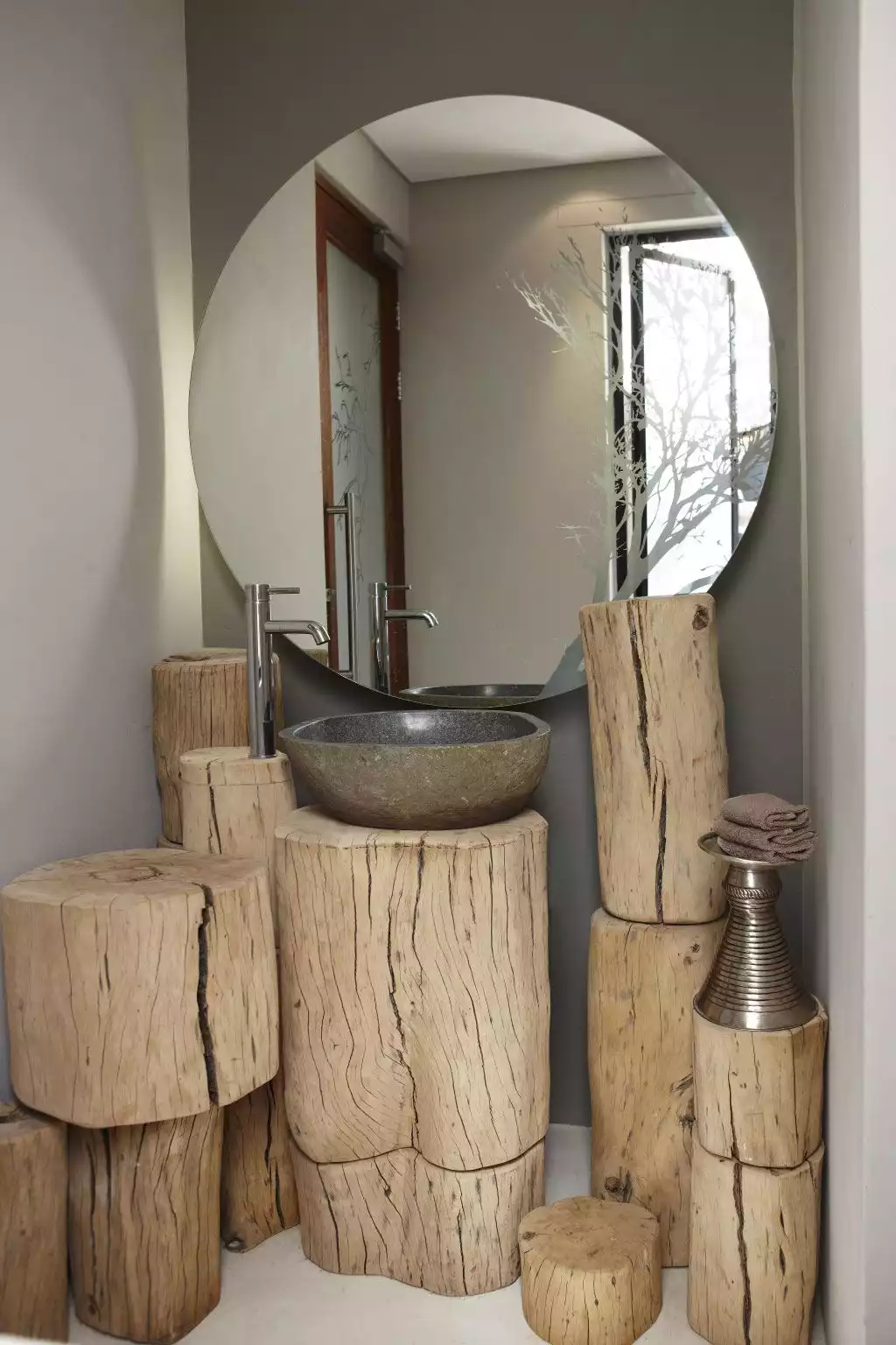 Unique rustic bathroom interior design featuring wood stump