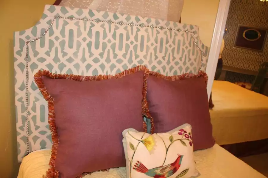 Upholstered headboard featuring stenciled fabric