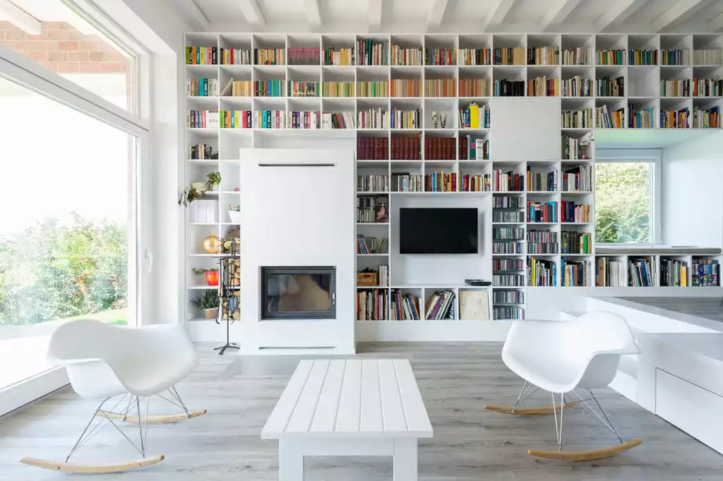 White living room With a Large Wall Library 1024x681